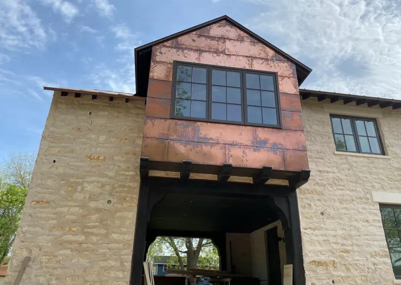 Copper metal panel facade on a stone building for Skylight Installation in Arvin